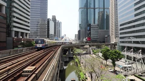 BTS Skytrain in Bangkok, passing train in the background of the city. Stock Footage 130182669