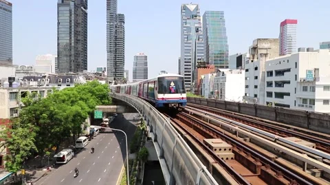 BTS Skytrain in Bangkok, passing train in the background of the city. Stock Footage 130182723