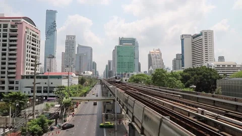 BTS Skytrain in Bangkok, passing train in the background of the city. Stock Footage 130186144