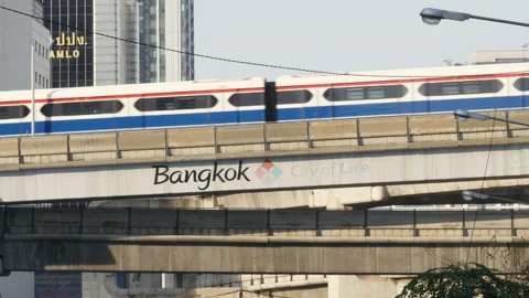 BTS Skytrain moving on elevated track over Bangkok City of Life sign Stock Footage 323067665