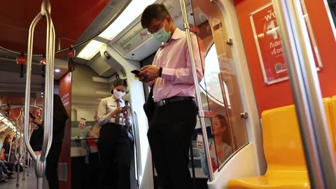 BTS Skytrain passengers inside the car, people in medical masks Stock Footage 130181464