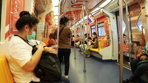 BTS Skytrain passengers in a subway car in Bangkok, people in medical masks. Stock Footage 130181061