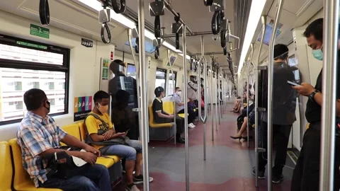 BTS Skytrain passengers in a subway car in Bangkok, people in medical masks. Stock Footage 130184876