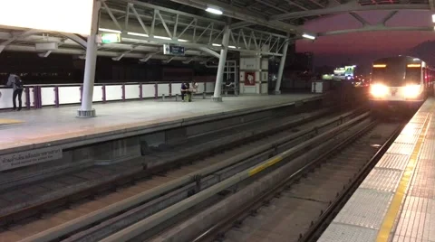 BTS train arriving at Phrom Phong station in Bangkok Stock Footage 63512869