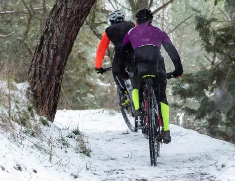 Btt cyclists get out of focus in the snow. Extreme mtb in the snow Stock Photos