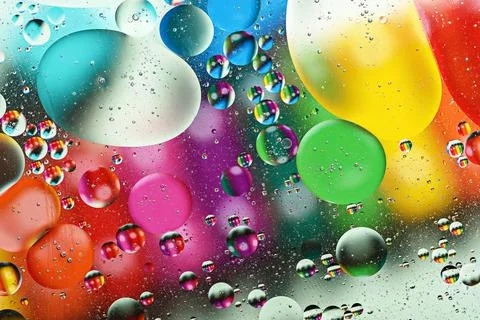 Bubble background, colorful multicolored drops of oil on water, sacred space Stock Photos