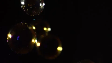 Bubble blower falling on a black background in slow motion Stock Footage 272173860