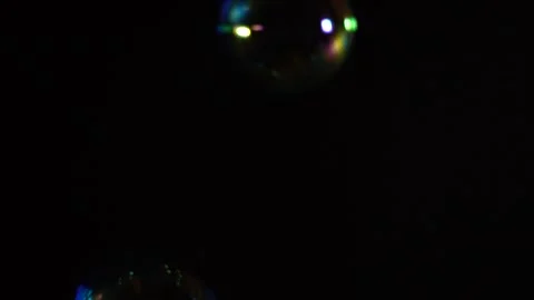 Bubble blower falling on a black background in slow motion Stock Footage 272220630
