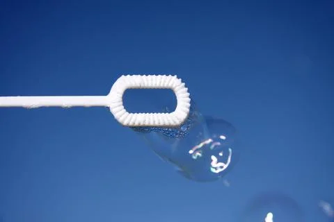 Bubble blown against a clear blue sky background 스톡 사진