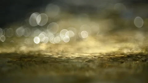 Bubble bokeh of sunlight reflections on a mountain river (close up, slow motion) Video stock 211756182