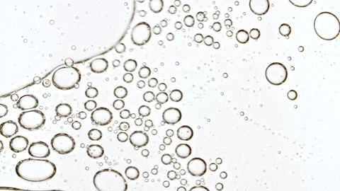 Bubble cluster, cells under a microscope. Transparent cosmetic gel fluid with Video stock 275967923