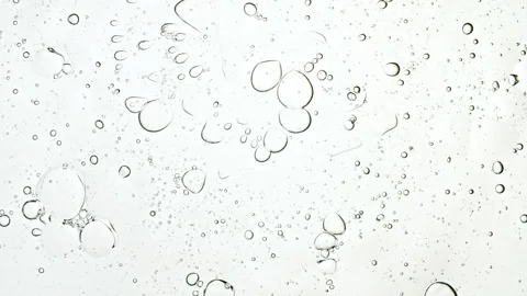 Bubble cluster, cells under a microscope. Transparent cosmetic gel fluid with Video stock 276532099