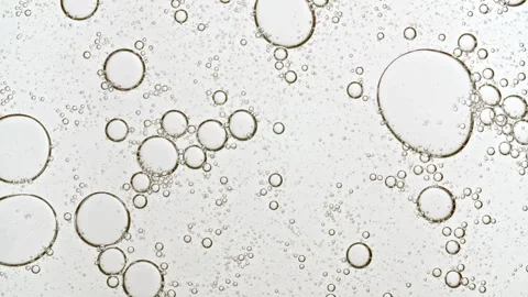 Bubble cluster, cells under a microscope. Transparent cosmetic gel fluid with Stock Footage 276995818
