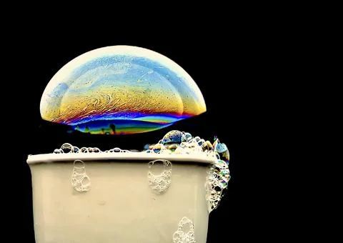 Bubble with colorful abstract patterns on a black background Stock Photos