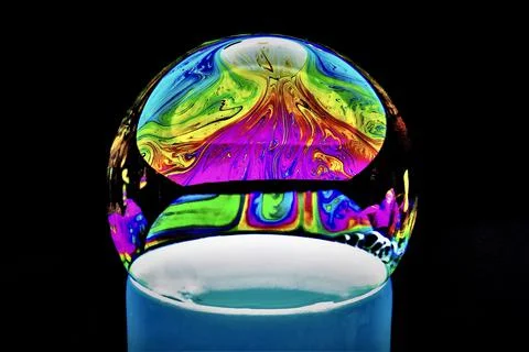 Bubble with colorful abstract patterns on a dark background Stock Photos