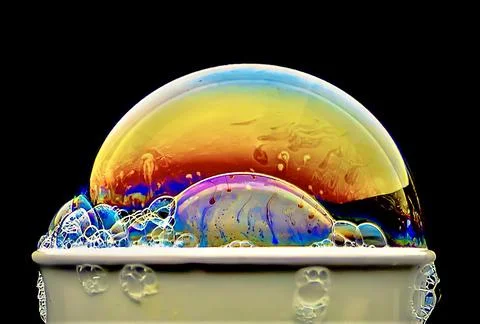 Bubble with colorful abstract patterns on a dark background Stock Photos