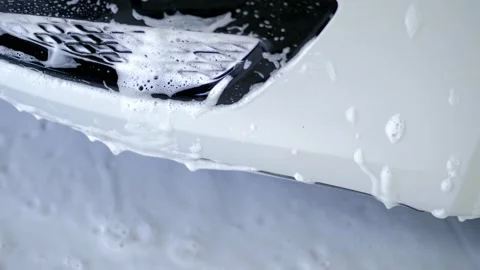 Bubble draining on the white car, special thick foam from non-contact high Stock Footage 230991244