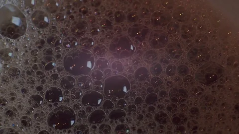 Bubble foam in a dark liquid Stock Footage 116902829