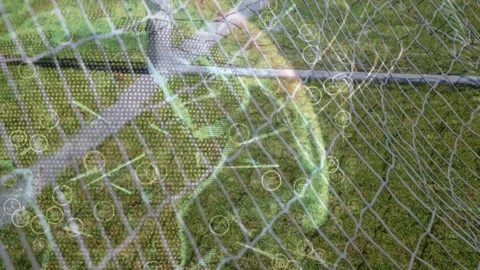 Bubble forming and drifting over chain-link fence and grass, HUD dots Stock Footage 333318199