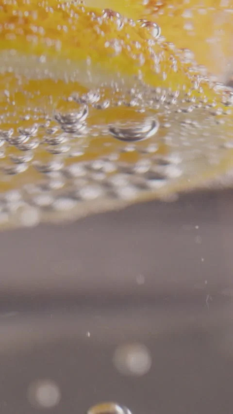 A bubble of gas rises up and sticks to a slice of lemon 動画素材 237706121