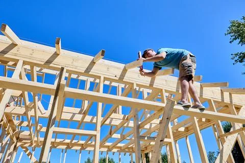 Bubble level held against wood framing to verify upright placement of timbe.. Stock Photos