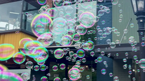 Bubble machine blows rapid fire bubbles at outdoor event 動画素材 327870418