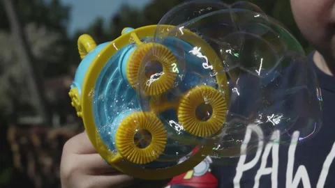 Bubble machine in the hand of a child Stock Footage 154938811
