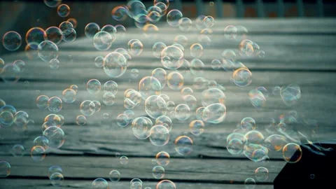 Bubble machine producing colorful soap bubbles in sunlight Stock Footage 342347559