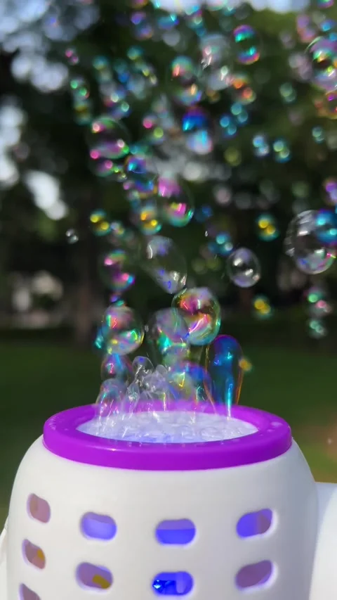 Bubble machine with transparent multicolored colorful soap bubbles 動画素材 327885023