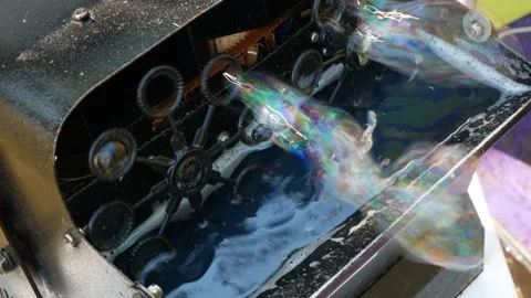 Bubble maker at work. Bubble machine blowing non-stop soap bubbles Stock Footage 244105642