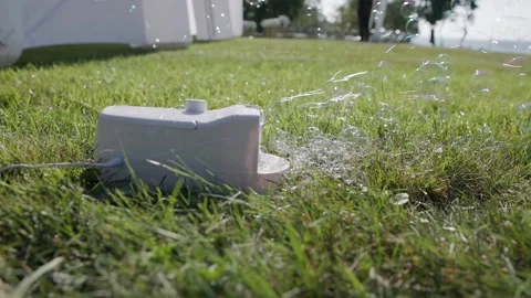 Bubble making device on ground at wedding in slo mo Stock Footage 252395133