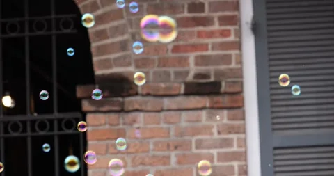 The bubble man on a balcony making bubbles in the French Quarter in New Orleans. Stock Footage 268760659