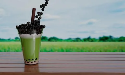 Bubble milk green tea in a clear glass and brown straws placed on a wooden .. Ilustración de archivo