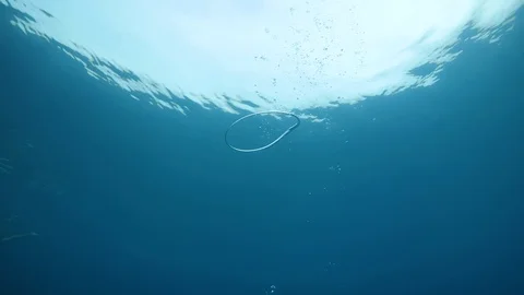 Bubble ring slowly breaking underwater. Stock Footage 127492211