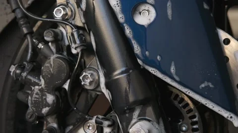 Bubble shampoo on midnight blue motorcycle suspension. Stock Footage 147390145