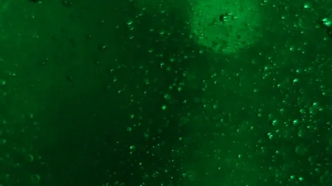 Bubble Surges on green Background Stock Footage 124397868