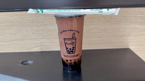 Bubble Tea with Eco-Friendly Paper Straw Closeup - 4K Editorial Stock Footage 332415317