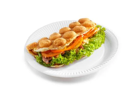 Bubble waffle with fried bacon, eggs, tomato and salad Stock Photos