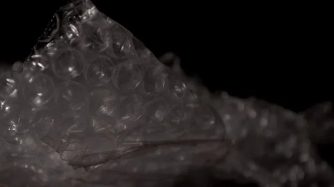 Bubble wrap and light effect, isolated on a black background. Stock Footage 117525816
