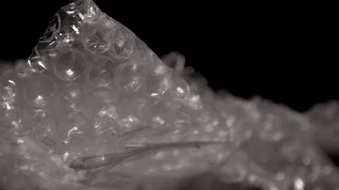 Bubble wrap isolated on a black background. Stock Footage 117525743