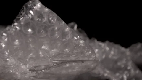 Bubble wrap isolated on a black background. Packaging plastic. Stock Footage 117525878