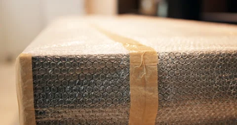 Bubble wrap, packaging and shipping with box for safety, delivery service and Stock Footage 337017313