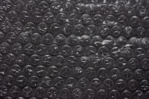 Bubble wrap packing on dark black background Stock Photos