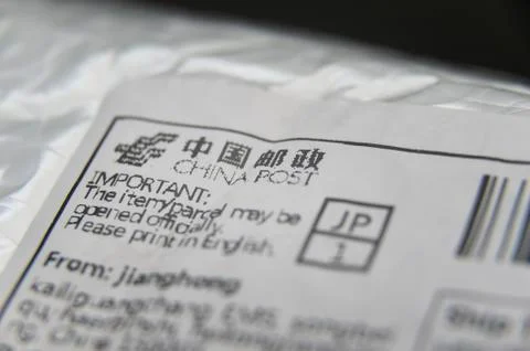 Bubble wrap padded envelope with close- up on China Post label. Stock Photos