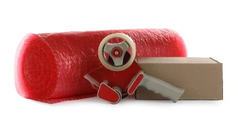 Bubble wrap roll, cardboard box and tape dispenser on white background Stock Photos