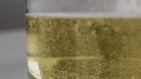 Bubbled up liquid mixing with changing colors, swirling process in chemical test Stock Footage 106469658