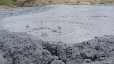 Bubbleling boiling active mud volcano Stock Footage 118816819
