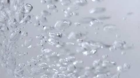 Bubbles aggressivley flowing through clear liquid Stock Footage 114086533