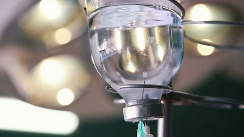 Bubbles of air rising in a drop counter made of glass in an airy hospital room Stock-Footage 127337814