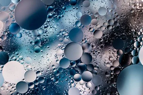 Bubbles and droplets create a mesmerizing abstract texture in blue tones Stock Photos